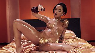 Honey Gold gets oiled up and pleasantly fucked in bed