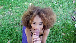 Curly haired teenie with beautiful smile sucks hard pecker outdoors